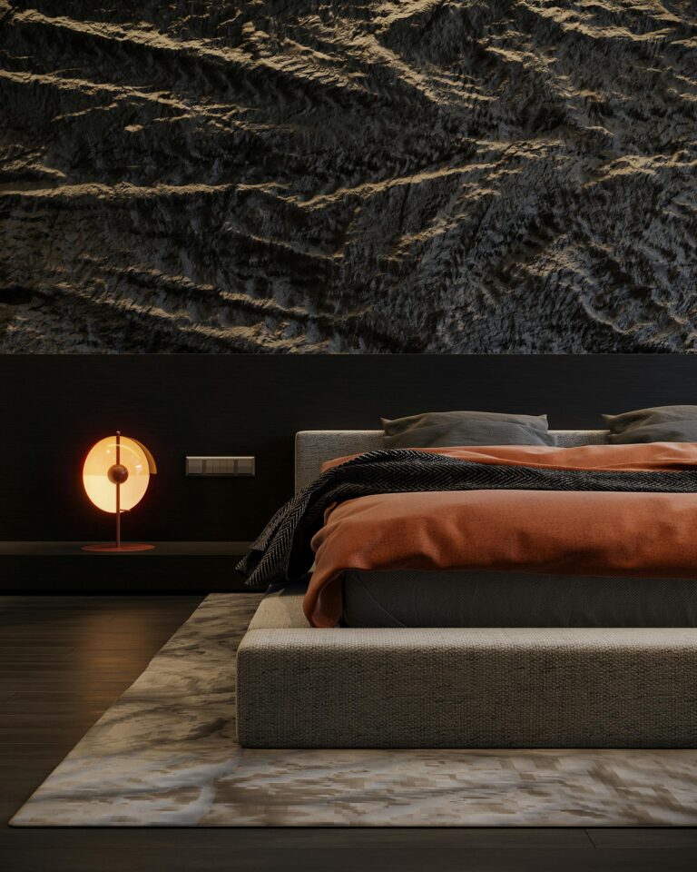 Sleek modern bedroom featuring textured walls, a cozy bed, and elegant lighting.